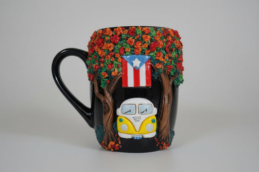 Decorative mug with a tree, car, and Puerto Rican flag design on a wooden surface.